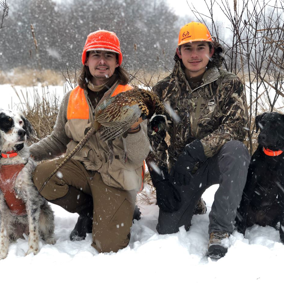 <h2>Snowy Success</h2>Daniel Sill of Luck, Wisc. and Brandon Wynn of Fort Calhoun, Neb. with a late-season longtail in western Wisconsin.<br />
<br />
“Heavy snow had the birds tucked into thick cattails, which made for tough walking but good shot opportunities,” Sill said. “Lox (L) made a nice point and flush, and Bruly (R) finished the sequence with a great retrieve.”