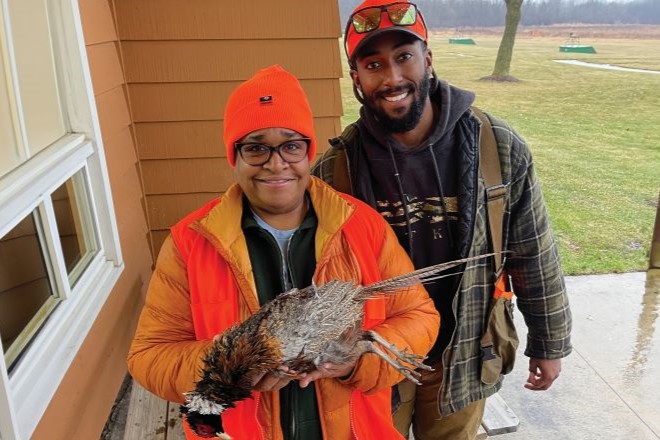 hunter shows off pheasant