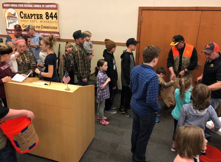 Youth lined up for a grocery grab bag of hunting and outdoor related goodies. Youth lined up for a grocery grab bag of hunting and outdoor related goodies.