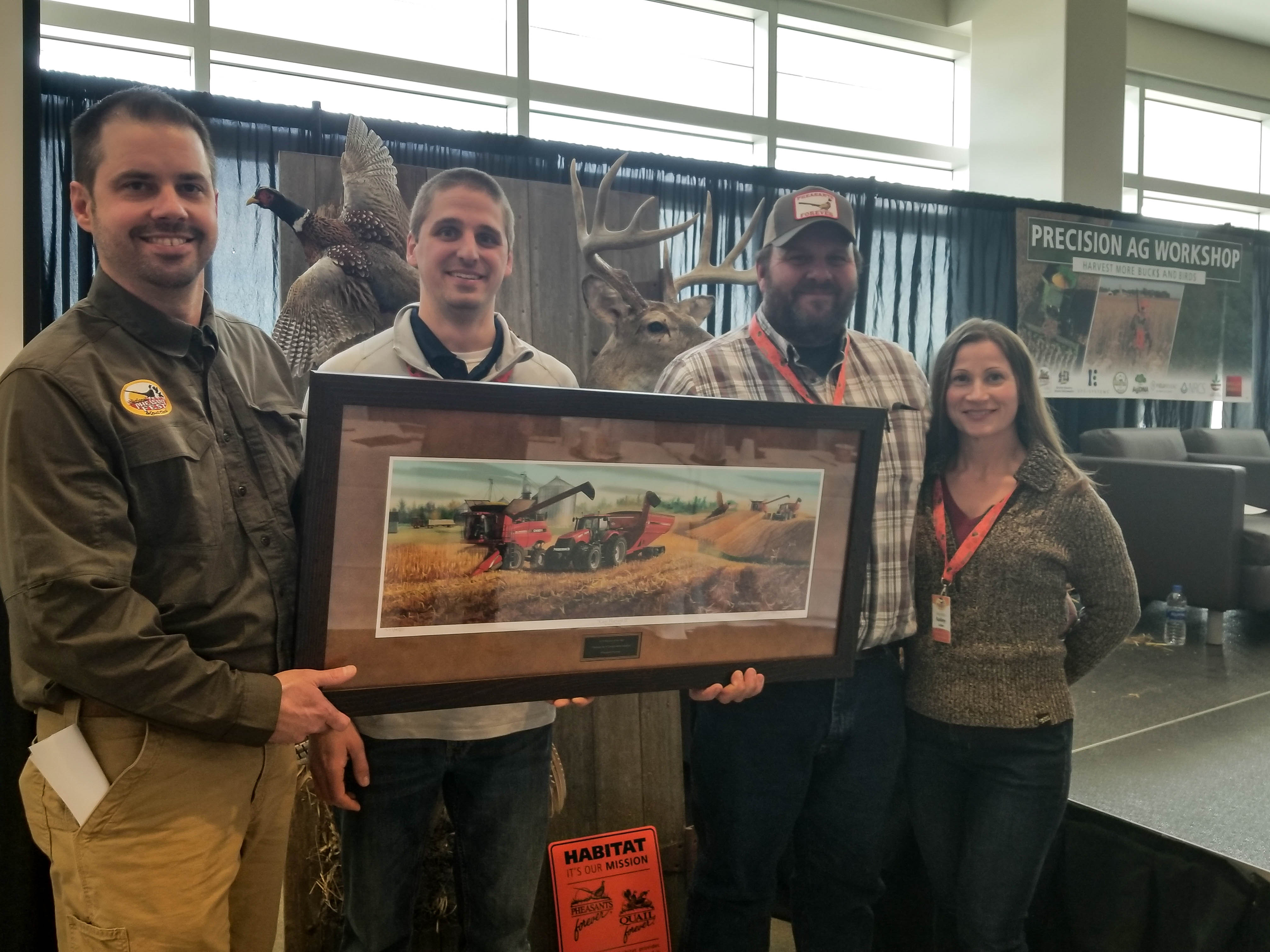 Jeff and Kelly Lake, at right, accept the Precision Ag Farmer of the Year Award from Pheasants Forever's Ryan Heiniger and Scott Stipetich, at left. Jeff and Kelly Lake, at right, accept the Precision Ag Farmer of the Year Award from Pheasants Forever's Ryan Heiniger and Scott Stipetich, at left.